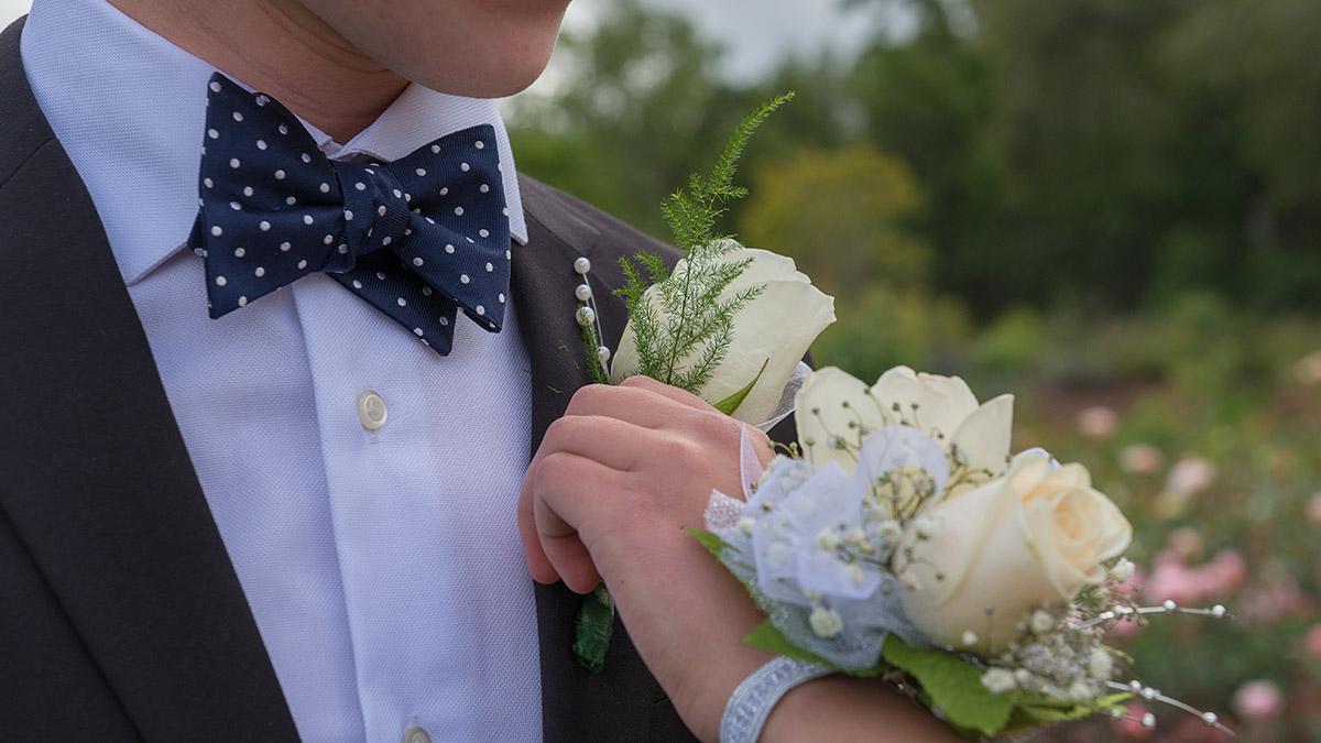 Article Cards Featured Image pinning boutonniere and corsage for prom or formal