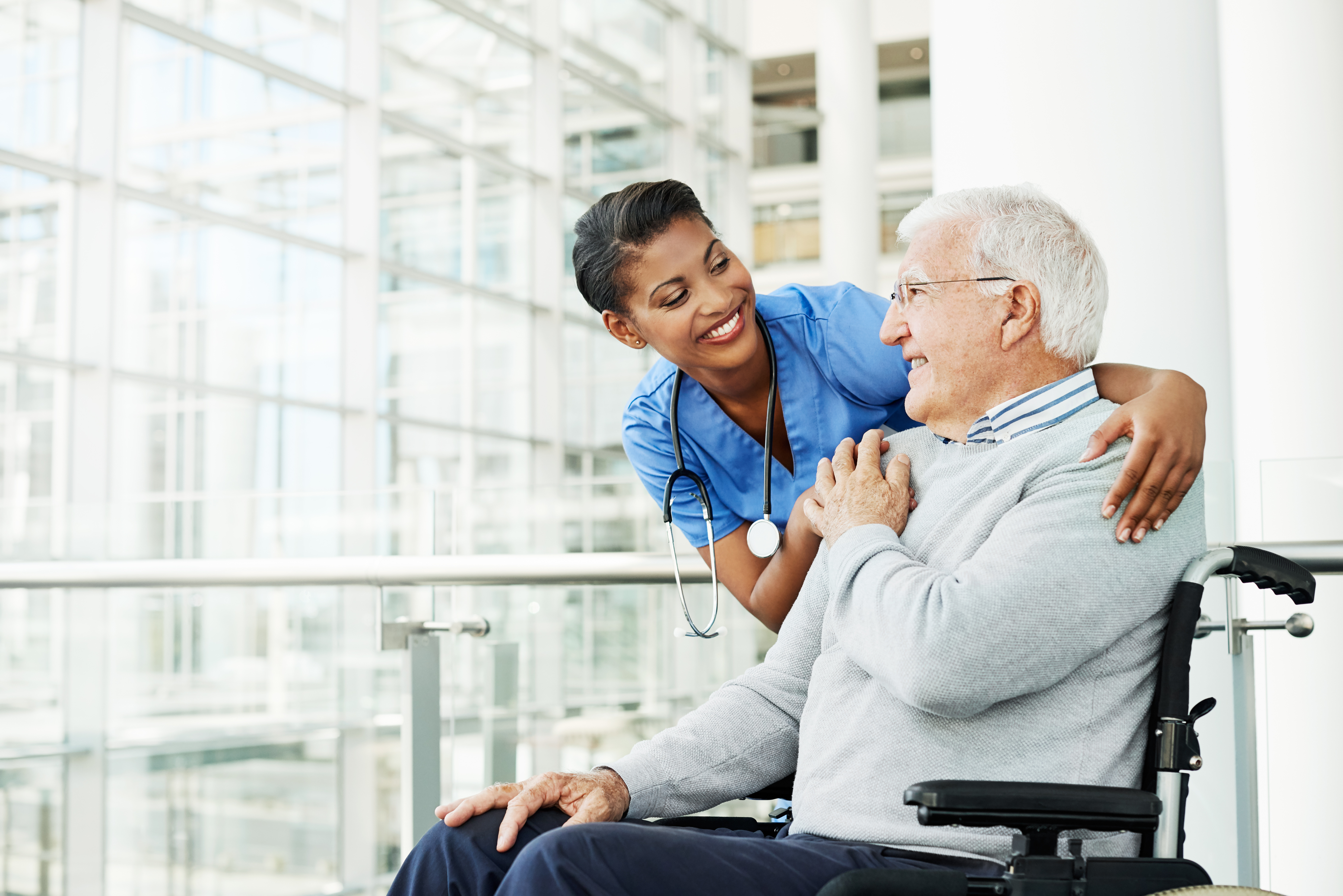 nurse helping man in wheelchair