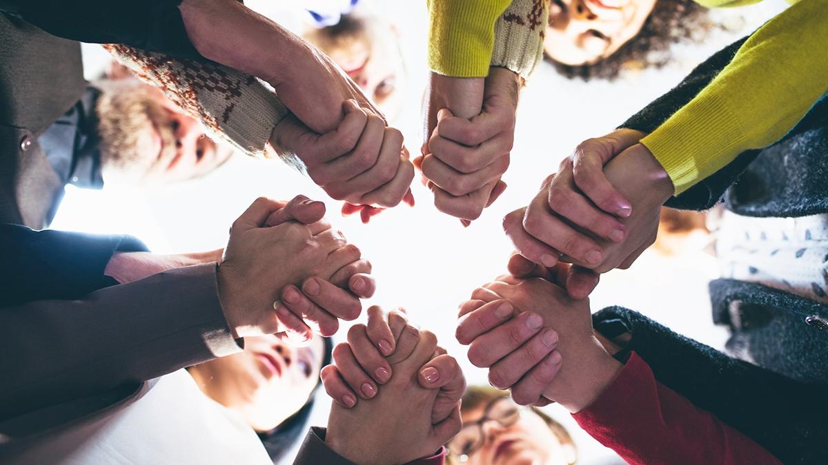 Article Cards Featured Image People who overcame grief holding each other by hands.