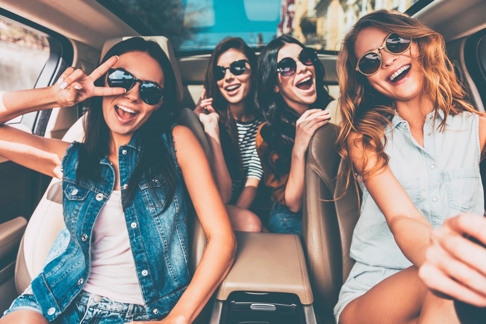 Article Cards Featured Image Four beautiful young cheerful women looking happy and playful while sitting in car