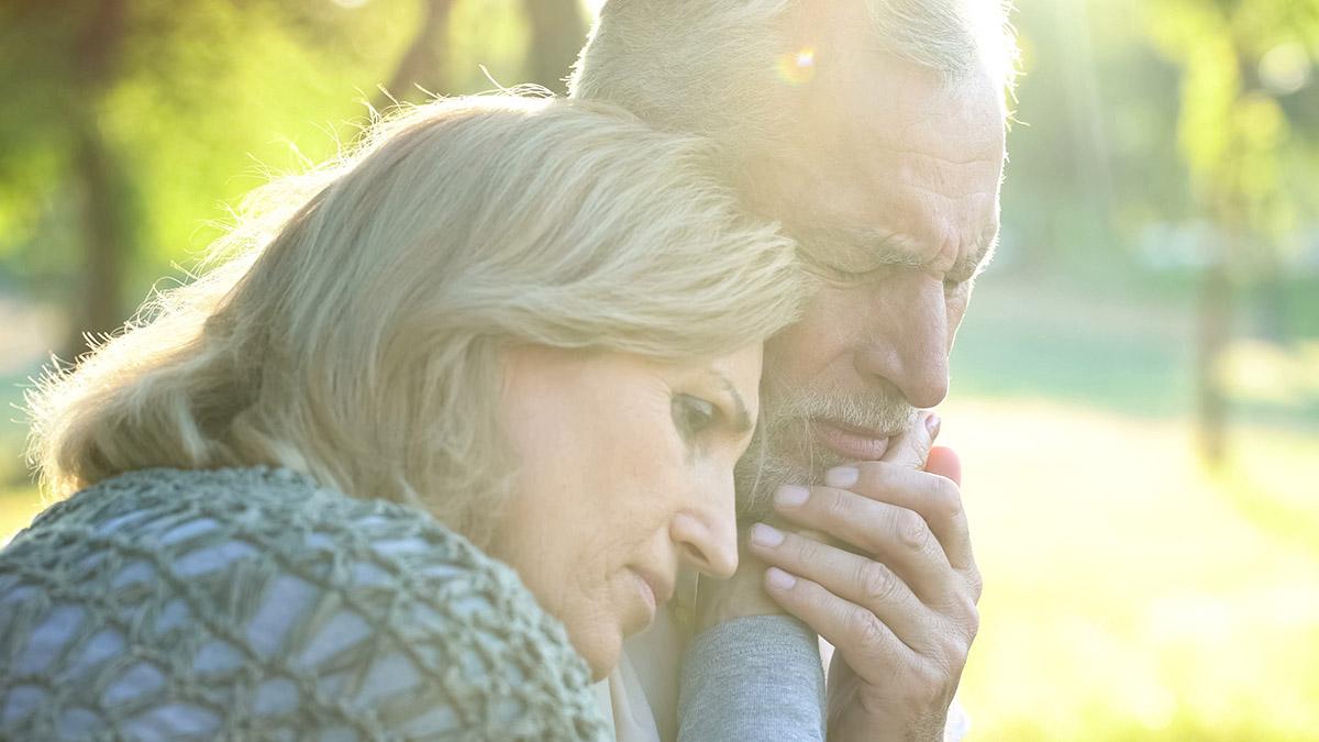 Article Cards Featured Image Sad senior wife embracing crying husband, relative loss, grief a