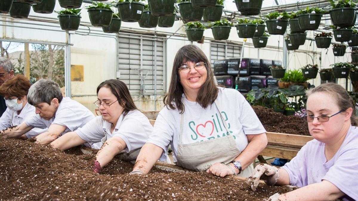 Article Cards Featured Image Smile Farms Famers work on a planting bed