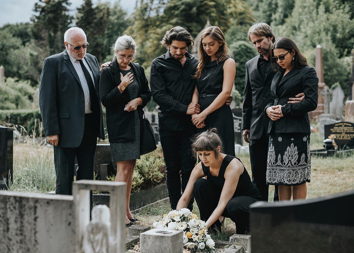 Article Cards Featured Image Family laying flowers on the grave