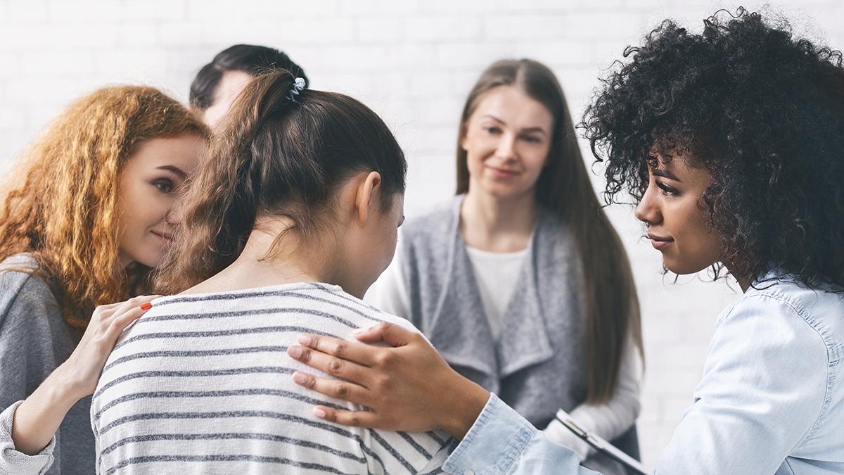 Article Cards Featured Image Support group patients comforting woman at therapy session