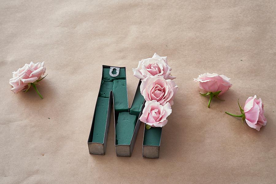 a photo of a mom floral centerpiece: flowers stuck in M