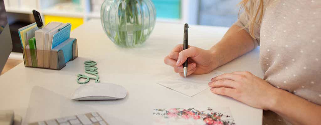 Photo of woman trying to figure out what to write in a sympathy card.