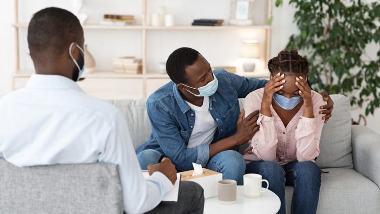 Grieving family wearing masks