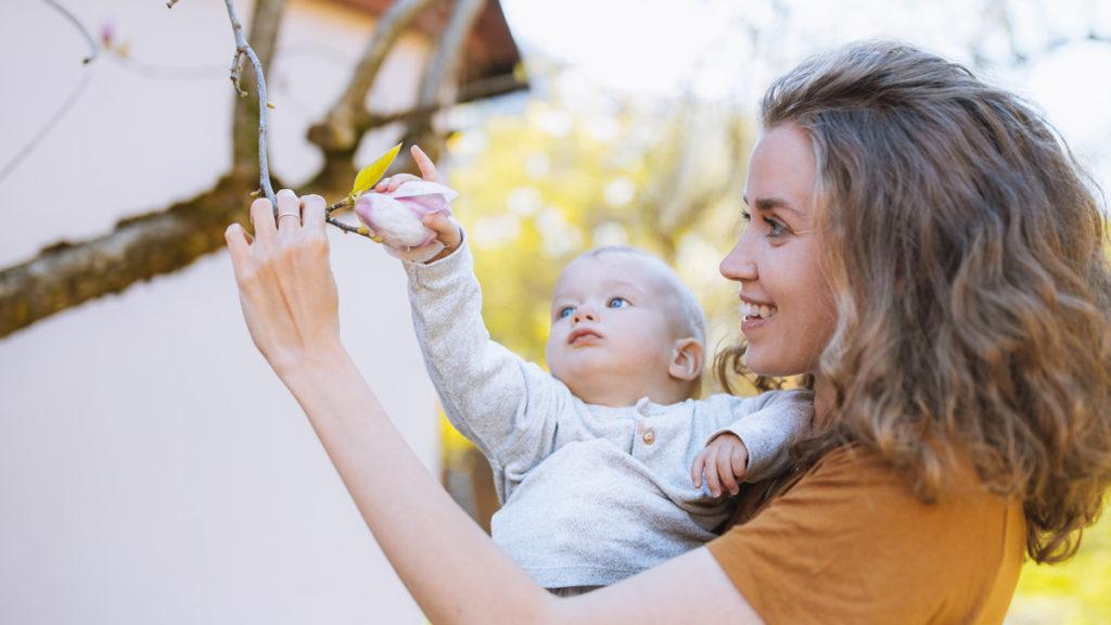 Mommy brain isn't bad    it's one of the benefits of motherhood and another reason to celebrate moms. In this photo, a mom shows her baby a tree branch.