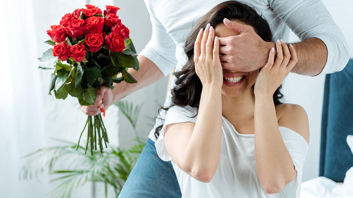 A photo of rose quotes with a man giving a woman a bouquet of roses