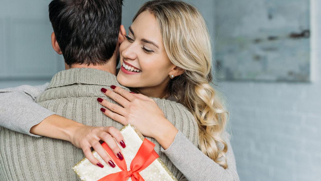 psychology of gifting with woman receiving a gift from a man.