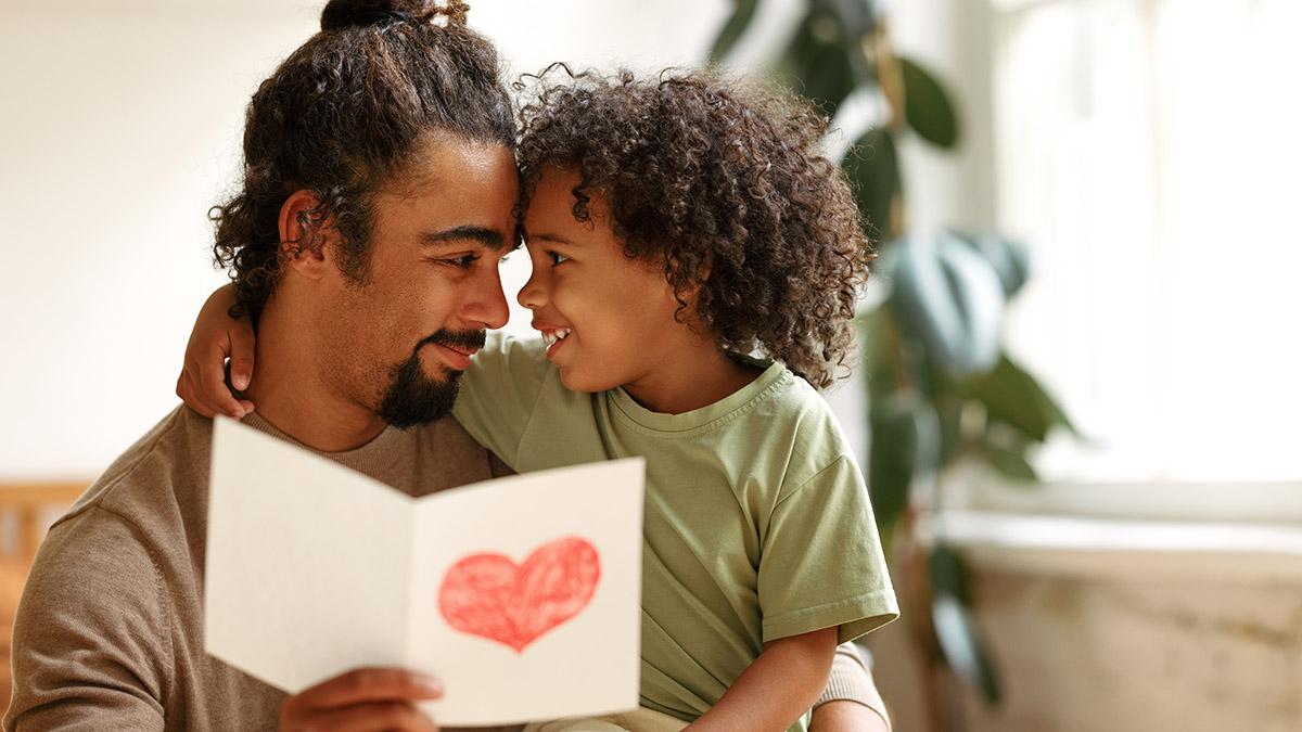 father's day messages with boy giving his father handmade greeting postcard on Fathers Day