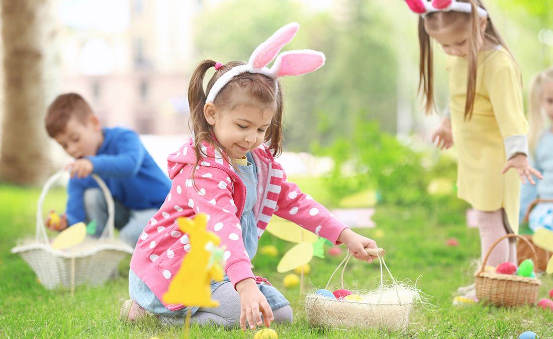 easter egg hunt with girl picking up easter eggs